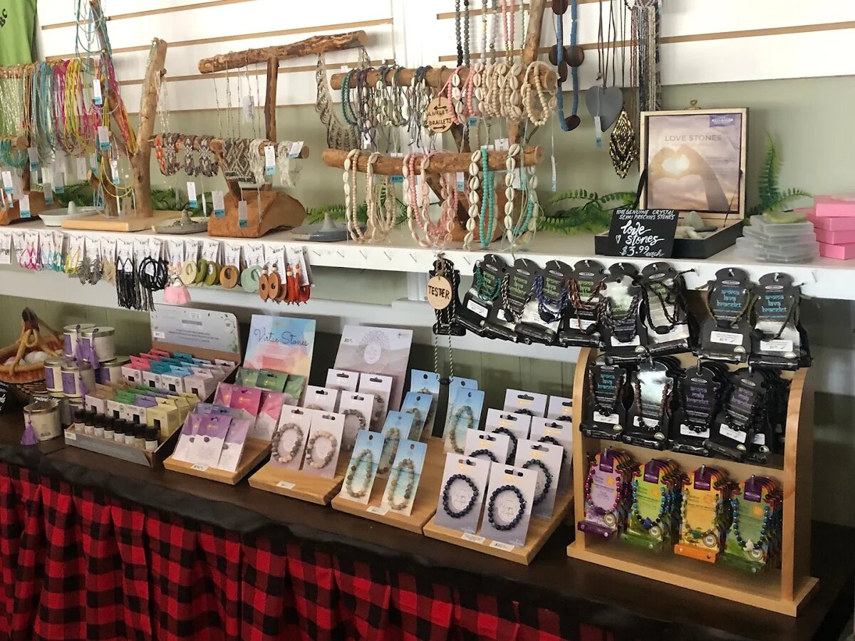 Gift shop display of handmade jewelry and earrings on a red-checkered table