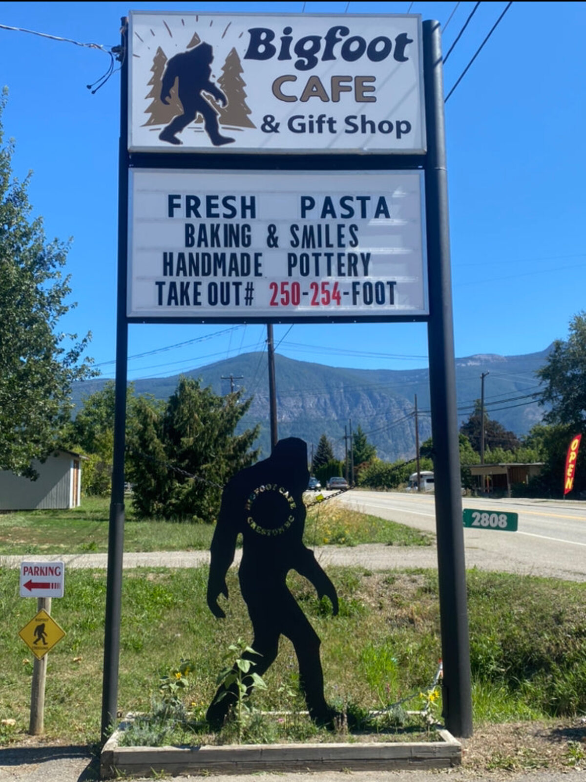 The real Bigfoot Cafe reader-board sign on Highway 3, with the Bigfoot statue beside it